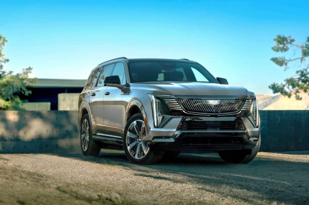 A silver Cadillac Escalade IQL parked in a studio setting, showcasing its design.